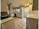 Well-lit kitchen showcases white cabinetry, modern appliances, and stylish tile flooring, offering both functionality and appeal at 12113 Calaboose Ct, Orlando, FL 32828