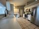 Bright kitchen featuring stainless steel appliances, white cabinets, and a tile backsplash, creating a clean and modern aesthetic at 12113 Calaboose Ct, Orlando, FL 32828