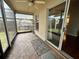 Enclosed patio offering a serene outdoor space with stone flooring, ceiling fan, and views of the backyard and pergola at 12113 Calaboose Ct, Orlando, FL 32828
