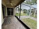 Enclosed patio offering a seamless transition to the outdoor living area with a view of the backyard pergola and playground at 12113 Calaboose Ct, Orlando, FL 32828