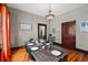 Dining room features a wooden table, seating for six, and a decorative hanging light fixture at 501 Washington Ave, Eustis, FL 32726