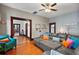 Inviting living room featuring hardwood floors, a plush sectional sofa, and an open doorway to the kitchen at 501 Washington Ave, Eustis, FL 32726