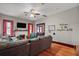 Cozy living room features a brick fireplace, hardwood floors, modern furniture, and a TV at 501 Washington Ave, Eustis, FL 32726