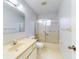 Well-lit bathroom featuring a vanity with a sink, a toilet, and a shower-tub combo, providing a practical space at 13729 Se 89Th Ave, Summerfield, FL 34491