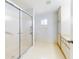 Bright bathroom featuring a walk-in shower and vanity with storage, perfect for a clean, functional design at 13729 Se 89Th Ave, Summerfield, FL 34491