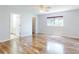 Bedroom featuring hardwood floors, a ceiling fan and en-suite bathroom perfect for a relaxing retreat at 13729 Se 89Th Ave, Summerfield, FL 34491