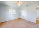 A cozy bedroom with a ceiling fan, closet, neutral walls, and plush carpeting offers a comfortable and inviting space at 13729 Se 89Th Ave, Summerfield, FL 34491