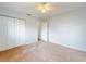 Spacious bedroom features a ceiling fan, plush carpeting, and double door closet at 13729 Se 89Th Ave, Summerfield, FL 34491