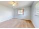 Bright, carpeted bedroom with a ceiling fan and great natural light from the window at 13729 Se 89Th Ave, Summerfield, FL 34491