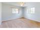 Bright bedroom features carpet, ceiling fan, and large windows for natural light, providing a relaxing space at 13729 Se 89Th Ave, Summerfield, FL 34491