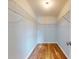 Walk-in closet with metal shelving and wood-look flooring, perfect for organization at 13729 Se 89Th Ave, Summerfield, FL 34491