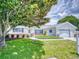 Charming single-story home with a well-manicured lawn, brick accents, and a two-car garage at 13729 Se 89Th Ave, Summerfield, FL 34491