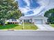 Charming single-story home with a well-manicured lawn, mature trees, and a two-car garage, perfect for suburban living at 13729 Se 89Th Ave, Summerfield, FL 34491