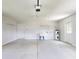 Spacious garage with ample storage space, a utility sink, and a side entry door at 13729 Se 89Th Ave, Summerfield, FL 34491