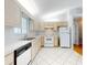Well-lit kitchen with white appliances, tile floors, and bright cabinets at 13729 Se 89Th Ave, Summerfield, FL 34491