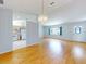 Open-concept space with hardwood floors, adjacent kitchen, and abundant natural light at 13729 Se 89Th Ave, Summerfield, FL 34491