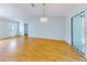 Bright living area features laminate floors, a chandelier, and sliding door access at 13729 Se 89Th Ave, Summerfield, FL 34491