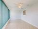 Well-lit room features tile floors, a ceiling fan, and sliding glass doors at 13729 Se 89Th Ave, Summerfield, FL 34491
