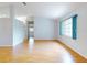 Bright and airy living room with hardwood floors and neutral walls, offering a versatile space for relaxation and entertainment at 13729 Se 89Th Ave, Summerfield, FL 34491