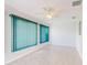 Well-lit room features tile floors, a ceiling fan, and vertical blinds at 13729 Se 89Th Ave, Summerfield, FL 34491