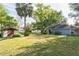 Expansive backyard with a shed, lush lawn, and mature trees creating a serene environment at 1606 Center St, Deland, FL 32720