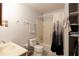 Bathroom with a tiled floor, standard toilet, a shower/bathtub combo, and storage shelves at 1606 Center St, Deland, FL 32720