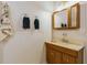 Modest bathroom featuring a wood vanity with mirror and decorative accents at 1606 Center St, Deland, FL 32720