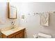 Bathroom featuring wood vanity, with a standard toilet and decorative towel racks at 1606 Center St, Deland, FL 32720