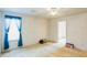 Bright bedroom features neutral carpet, a ceiling fan, and window with blue drapes at 1606 Center St, Deland, FL 32720