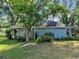 Charming single-story home with blue siding and mature trees in a shaded yard at 1606 Center St, Deland, FL 32720