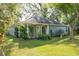 Exterior view of the home with blue siding, front lattice, and mature trees at 1606 Center St, Deland, FL 32720