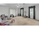 Bright living room with neutral carpet, ceiling fan, and plenty of natural light at 1606 Center St, Deland, FL 32720
