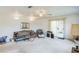 Large living room with sliding glass door, vintage furniture, and wall mirror at 1606 Center St, Deland, FL 32720