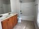 Bathroom featuring double sinks, vanity, and tiled tub-shower combo at 387 Winter Nellis Cir, Winter Garden, FL 34787