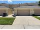 Exterior of the townhome with a large driveway and a tan garage door, number 387 is above it at 387 Winter Nellis Cir, Winter Garden, FL 34787