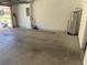 Spacious garage with water heater and breaker panel, offering ample storage at 387 Winter Nellis Cir, Winter Garden, FL 34787