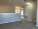 Carpeted upstairs landing with view of several bedrooms at 387 Winter Nellis Cir, Winter Garden, FL 34787