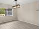 Sunlit dining area features modern lighting and views of the outdoor landscape at 15690 Sw 46Th Cir, Ocala, FL 34473