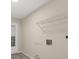 Large laundry room with storage shelf, utility sink hookups, and exterior door for easy access at 15690 Sw 46Th Cir, Ocala, FL 34473