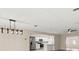 Bright living area with modern lighting and open floor plan flows into the kitchen at 15690 Sw 46Th Cir, Ocala, FL 34473