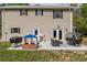 Back of the home with a patio set, grill, and playhouse for children at 3333 Se 3Rd Ave, Ocala, FL 34471