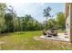 Lush backyard with seating and fire pit, perfect for relaxing and entertaining outdoors with trees and a shop at 3333 Se 3Rd Ave, Ocala, FL 34471