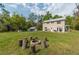 Expansive backyard featuring a fire pit, seating, and plenty of space for outdoor activities, with garage at 3333 Se 3Rd Ave, Ocala, FL 34471
