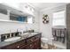 Bathroom featuring a double vanity with dark countertops and tile flooring at 3333 Se 3Rd Ave, Ocala, FL 34471