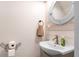 Cozy half bathroom features vanity with round mirror and modern fixtures at 3333 Se 3Rd Ave, Ocala, FL 34471