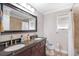 Bathroom featuring a double vanity with dark countertops and tile flooring at 3333 Se 3Rd Ave, Ocala, FL 34471