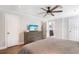 Bedroom showing ceiling fan, dresser with TV, and doorway to bathroom at 3333 Se 3Rd Ave, Ocala, FL 34471