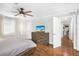 Bedroom with wood flooring, ceiling fan, and dresser with a television at 3333 Se 3Rd Ave, Ocala, FL 34471