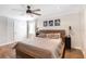 Bedroom featuring a ceiling fan, wooden floors, and sconce lights at 3333 Se 3Rd Ave, Ocala, FL 34471