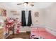 Playful bedroom featuring pink accents, custom shelves and hardwood flooring at 3333 Se 3Rd Ave, Ocala, FL 34471